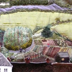 Fields, roads, hedges and bushes (as in the depiction of the Allotments, above) were embroidered either in situ directly on the calico, or using the same techniques as for the houses, or using materials with stitches applied for extra interest. 