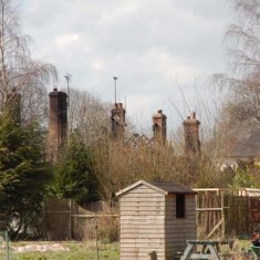 The view from the allotments, behind the cottages, shows the five chimney stacks still standing