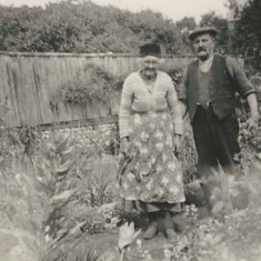 Couple in working clothes in garden