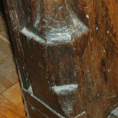 Carving at the foot of the door frame in the main room.