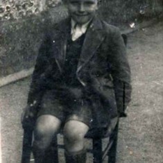 Alan Blackman sitting on the 'school chair'. His Headmistress during his early schooling, 1946 – 51, was the stern and somewhat miserable Mrs Gwendoline Hayes; she did manage to cheer and clap however when the Conservatives came to power in 1951. Of the Assistant Teachers, Alan remembers Miss Hastie, who often rapped childrens’ knuckles with the edge of her ruler, and Mrs Paul, who, although well-liked, shared Mrs Hayes’ nasty habit of blowing her nose then tucking the hanky up her knicker-leg. 
