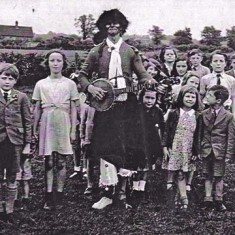 Schoolchildren with banjo 'minstrel'