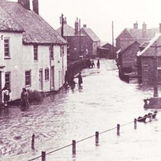 Barnards and War Memorial flooded Hazel Goddard on doorstep Barnards and War Memorial flooded. Hazel Goddard is standing on the doorstep