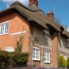 Bottle Ale Cottages, with four bottles embedded in the wall.