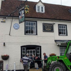 George facade and cherry picker, installing village broadband 2002. The wireless aerial  is being attached to the chimney at the George.