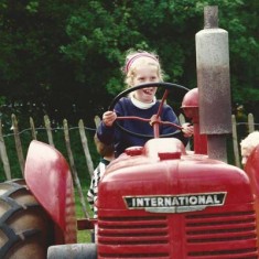 Girl 'driving' old tractor