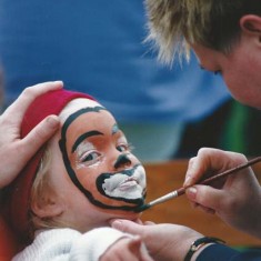 Girl having her face painted.