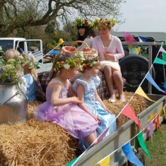 The May Queen arrives on a float.