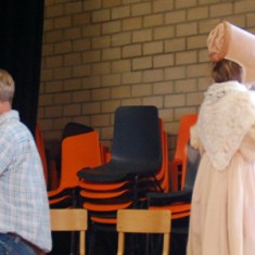 Small children trying historic costumes