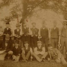A very early photograph showing men holding what look like quoits
