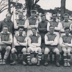 Back row, Gordon Maw, Len Cannings, Pat Lanham, George Munday, Ginger Phillips, Jim Brown Front row, Bert Cole, John James, Reg Lanham, Gus Cole, Pat Fielder, Tony Crockford, Terry Fielder. ‘Lawrence Blackman, in trench coat, looking every inch the 1950’s manager, with the football team. 