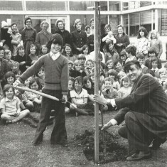 Jonathan Sparrow and Wynn Lewis, headmaster, planting tree in school grounds.