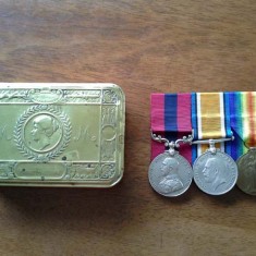 Edward Bone's medals and the tin in which they have been kept.